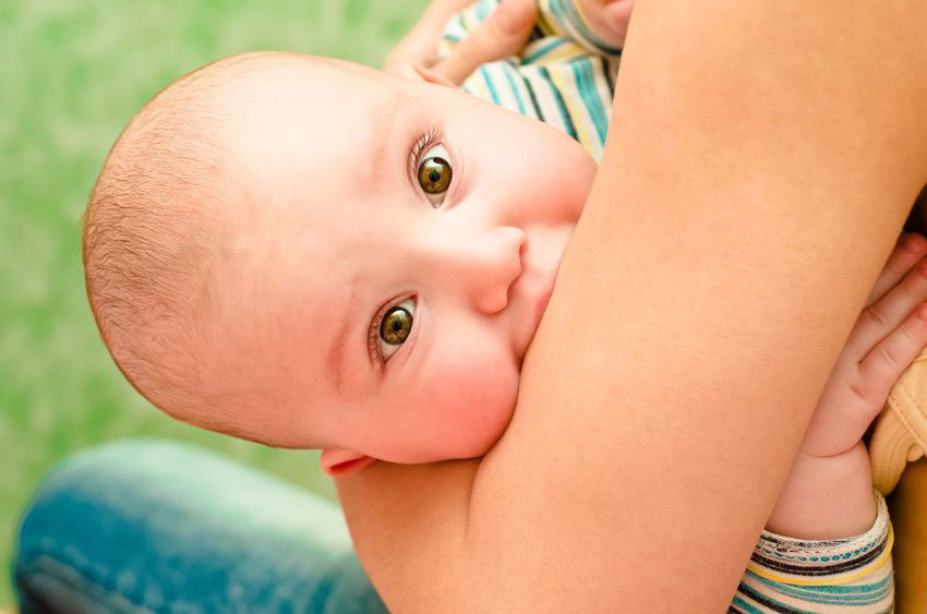 breastfeeding baby looking at camera
