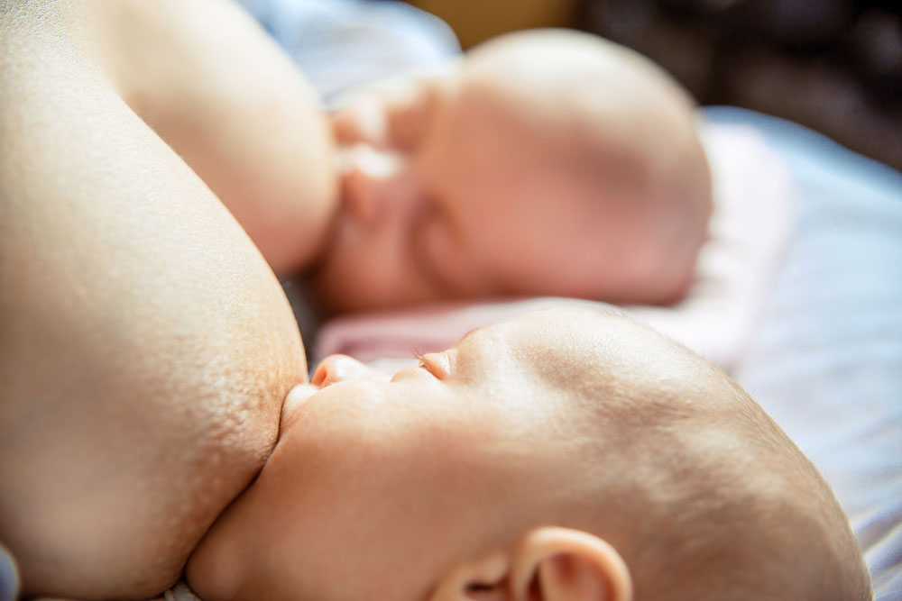 twins breastfeeding in rugby hold