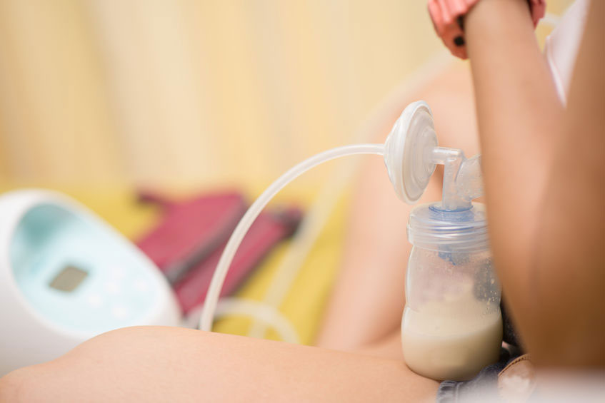 A mother using a breast pump
