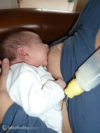 baby breastfeeding with a medela supplemental nursing system