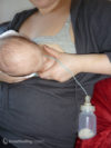 Baby breastfeeding with a homemade supplemental nursing system