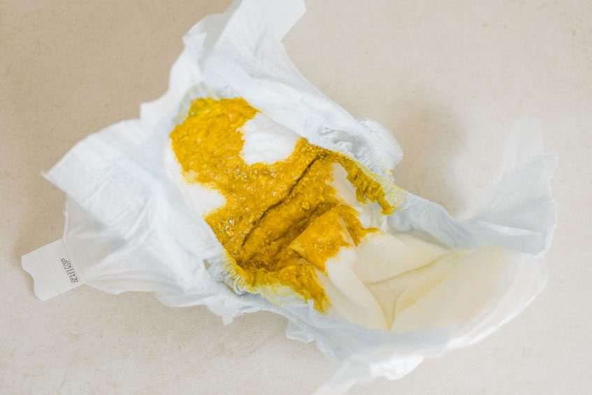 A soiled nappy showing yellow breastfed baby poo