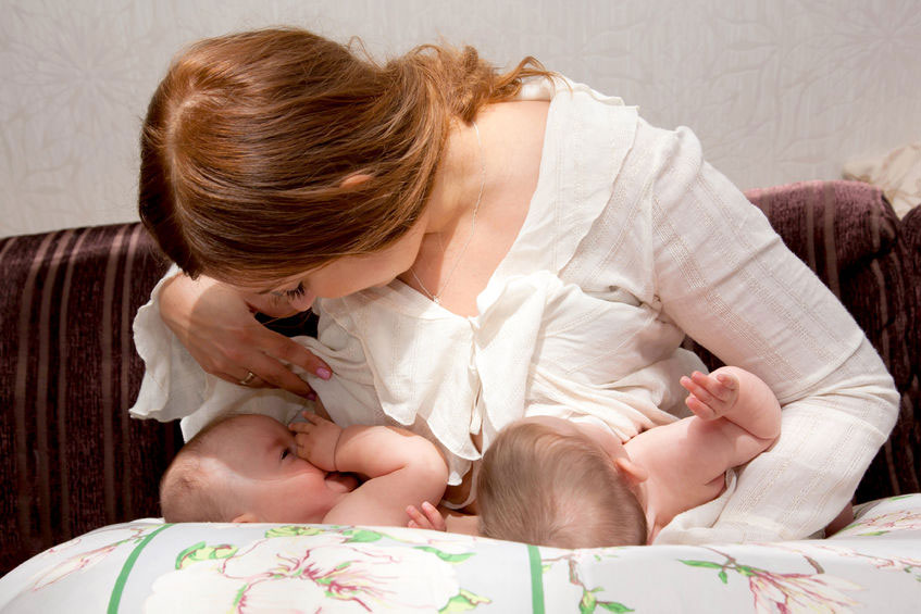 mother breastfeeding twins