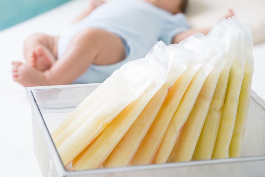 frozen milk in bags with baby in background