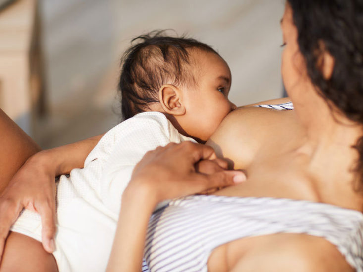 Mother reclines to breastfeed