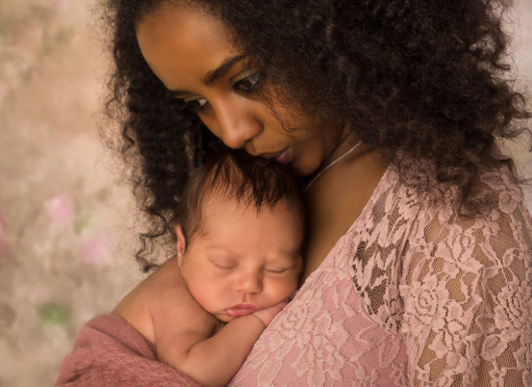 Mother holding sleeping baby on her chest