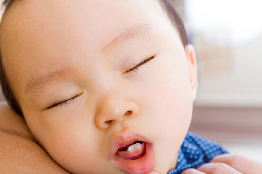 baby biting bottle teat