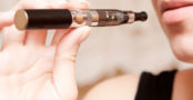 A woman holding an electronic cigarette