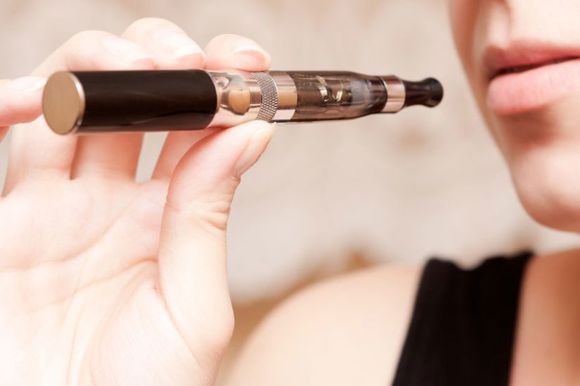 A woman holding an electronic cigarette