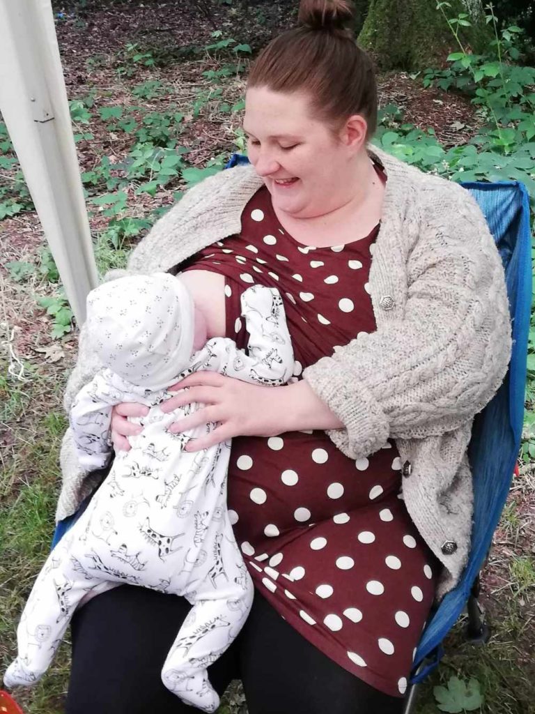 Baby breastfeeding in a straddle hold