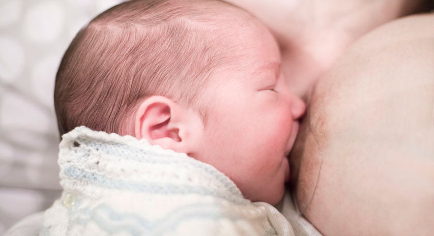 baby breastfeeding with a nipple shield