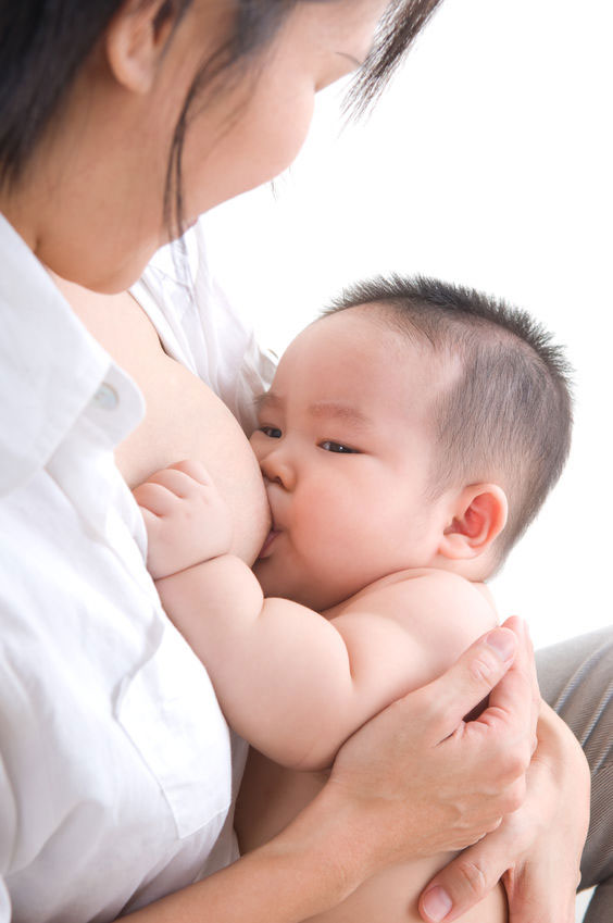 Baby frowning slightly and breastfeeding