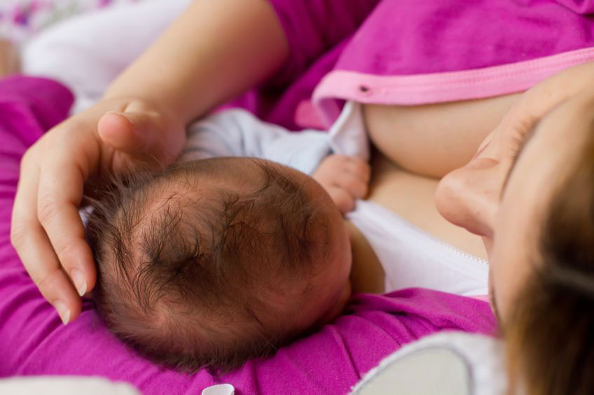 Mother breastfeeding lying down