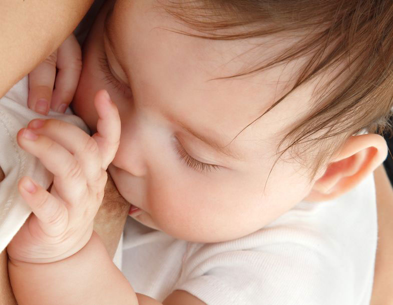 Baby breasteding with eyes closed